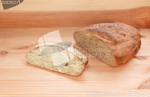 Image of Buttered slice of bread with the remaining loaf 