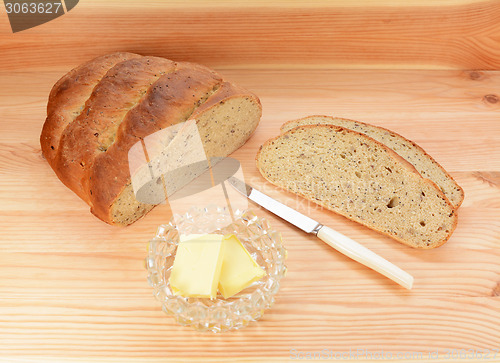 Image of Slices of fresh bread with pats of butter 