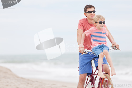 Image of family biking at the beach