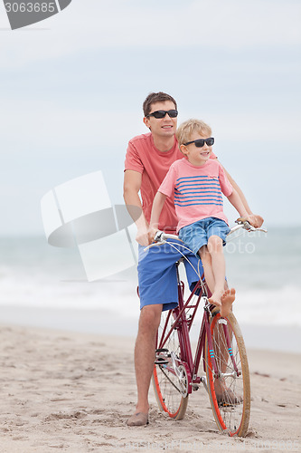 Image of family biking at the beach