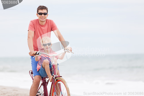 Image of family biking at the beach