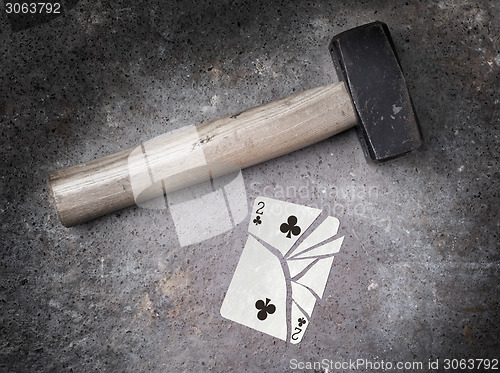 Image of Hammer with a broken card, two of clubs