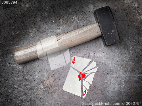 Image of Hammer with a broken card, ace of hearts