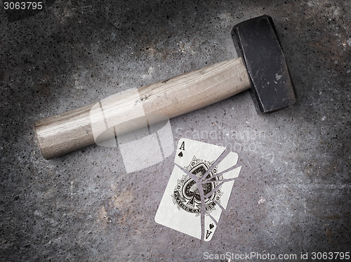 Image of Hammer with a broken card, ace of spades