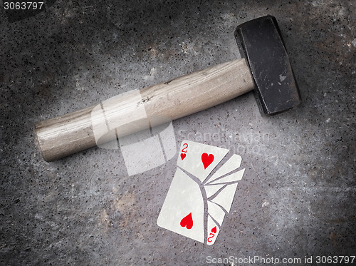 Image of Hammer with a broken card, two of hearts
