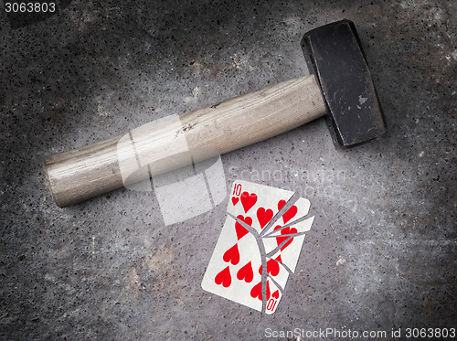 Image of Hammer with a broken card, ten of hearts