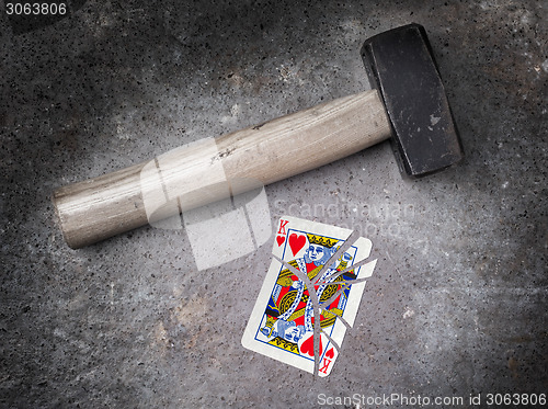 Image of Hammer with a broken card, king of hearts