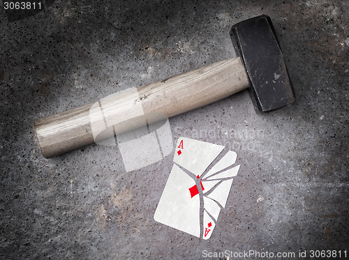 Image of Hammer with a broken card, ace of diamonds