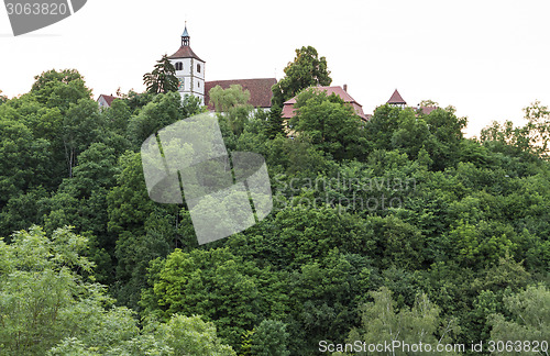 Image of historical building hidden behind trees