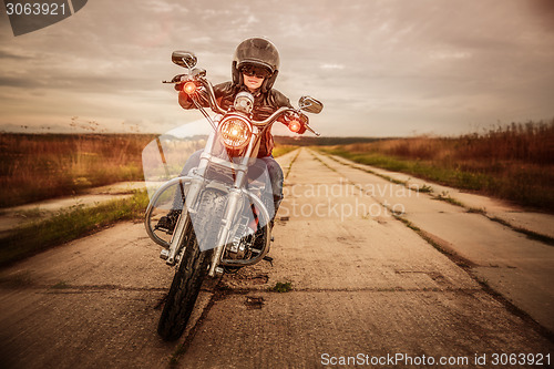 Image of Biker girl on a motorcycle