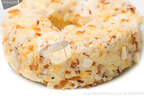 Image of Round sweet dessert cheese with nuts and pineapple closeup