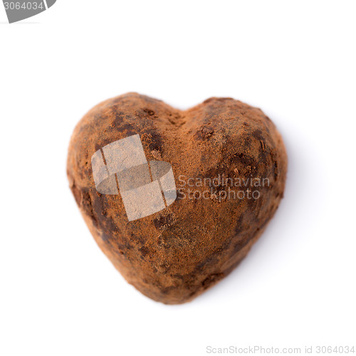 Image of One truffle candy in a heart shape. Valentine's Day.