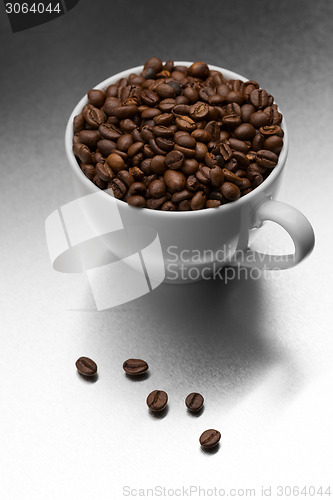 Image of Cup of coffee, full of beans.
