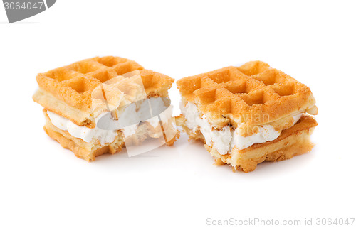 Image of Waffle with cream a broken in half.