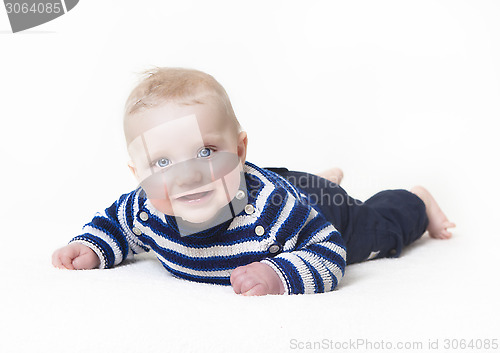 Image of baby lying looking at camera