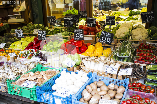 Image of Counter market with vegetables and mushrooms.