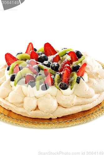 Image of Pavlova dessert with berries and kiwi.