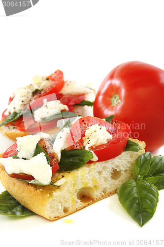 Image of Sandwich with tomato, cheese and basil.