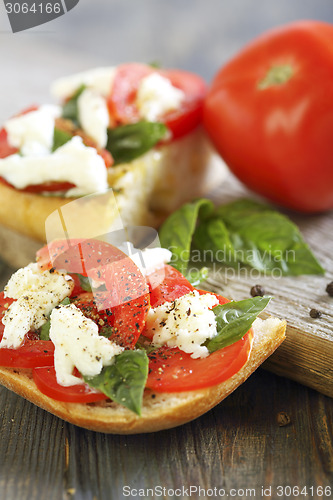 Image of Ciabatta with tomatoes, cheese and basil.