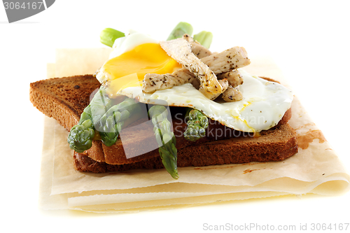 Image of Rye bread with asparagus, eggs and turkey.