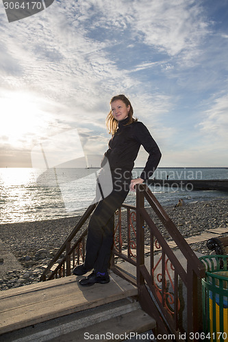 Image of Beautiful girl in the rays of the setting sun.