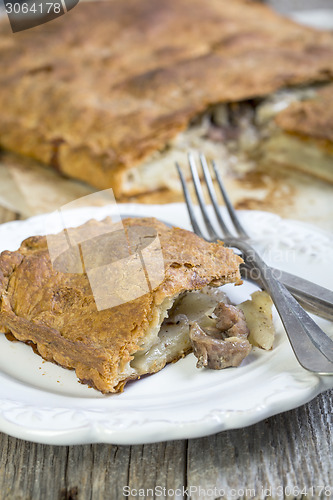 Image of Piece of homemade cake with meat.