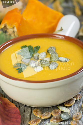 Image of Pumpkin soup with seeds and parsley.