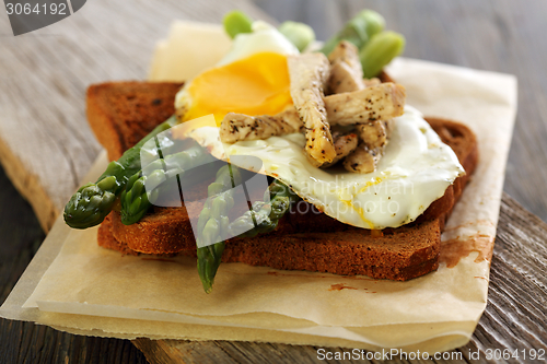 Image of Toast with green asparagus and egg.