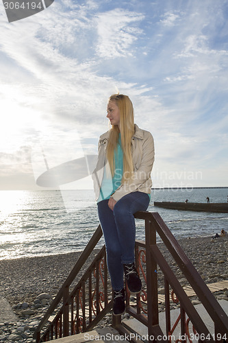 Image of Beautiful blonde looks at the sea.