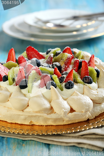 Image of Pavlova dessert with fresh berries.