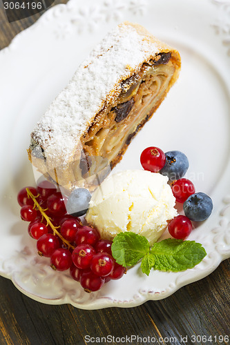 Image of Strudel with apples, ice cream and berries.