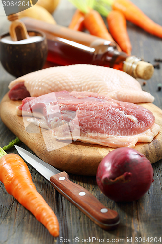 Image of Raw duck breast and vegetables. 