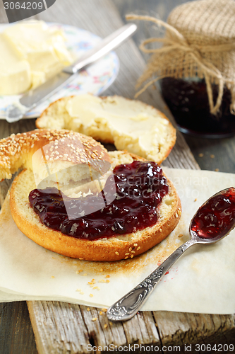 Image of Bagel with jam and butter.