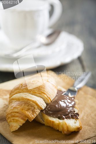 Image of Croissant with chocolate on a sheet of parchment.