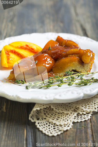 Image of Plate with peach pie and thyme.