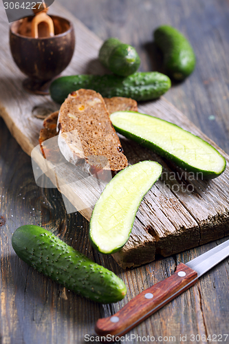 Image of Black bread and fresh cucumbers.