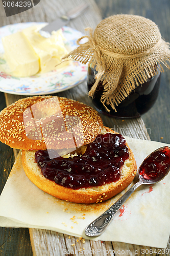 Image of Bagel with butter and jam for breakfast.