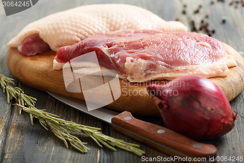 Image of Duck breast, rosemary and red onion.