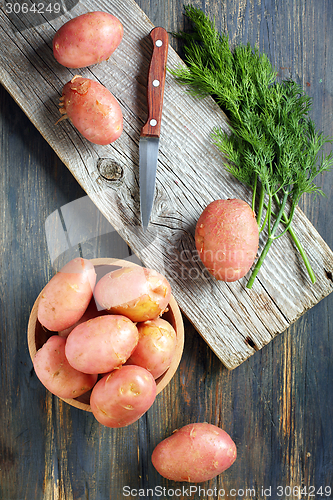 Image of Potatoes, dill and knife.