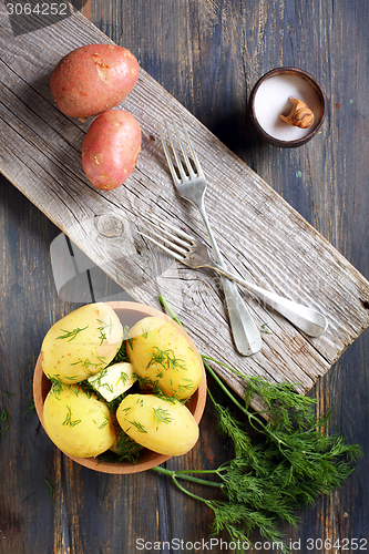 Image of Potatoes, dill, salt shaker and forks.
