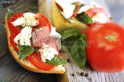 Image of Ciabatta with tomatoes, cheese and basil close-up.