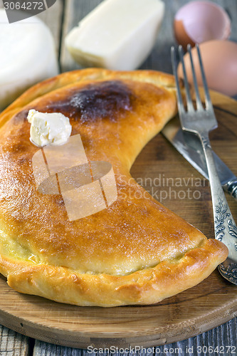 Image of Cheese pie with a slice of butter.