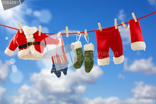 Image of Clothing Santa's on the rope.