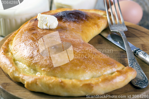 Image of Khachapuri with a piece of butter.