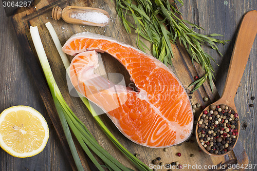 Image of Salmon, lemon,onion and spices.