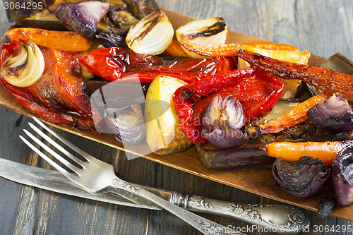 Image of Roasted vegetables, fork and knife.