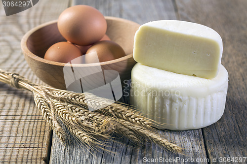 Image of Cheese, eggs and wheat ears .