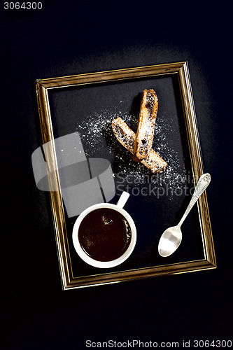 Image of Coffee, biscotti and a teaspoon.