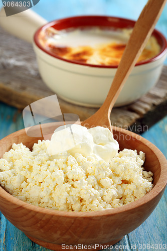 Image of Cheese and sour cream in a wooden bowl.