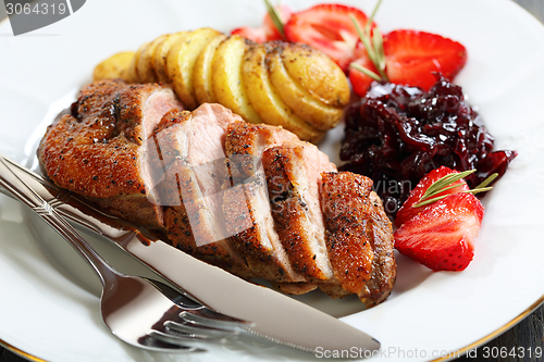 Image of Duck breast with a sauce of red onion.